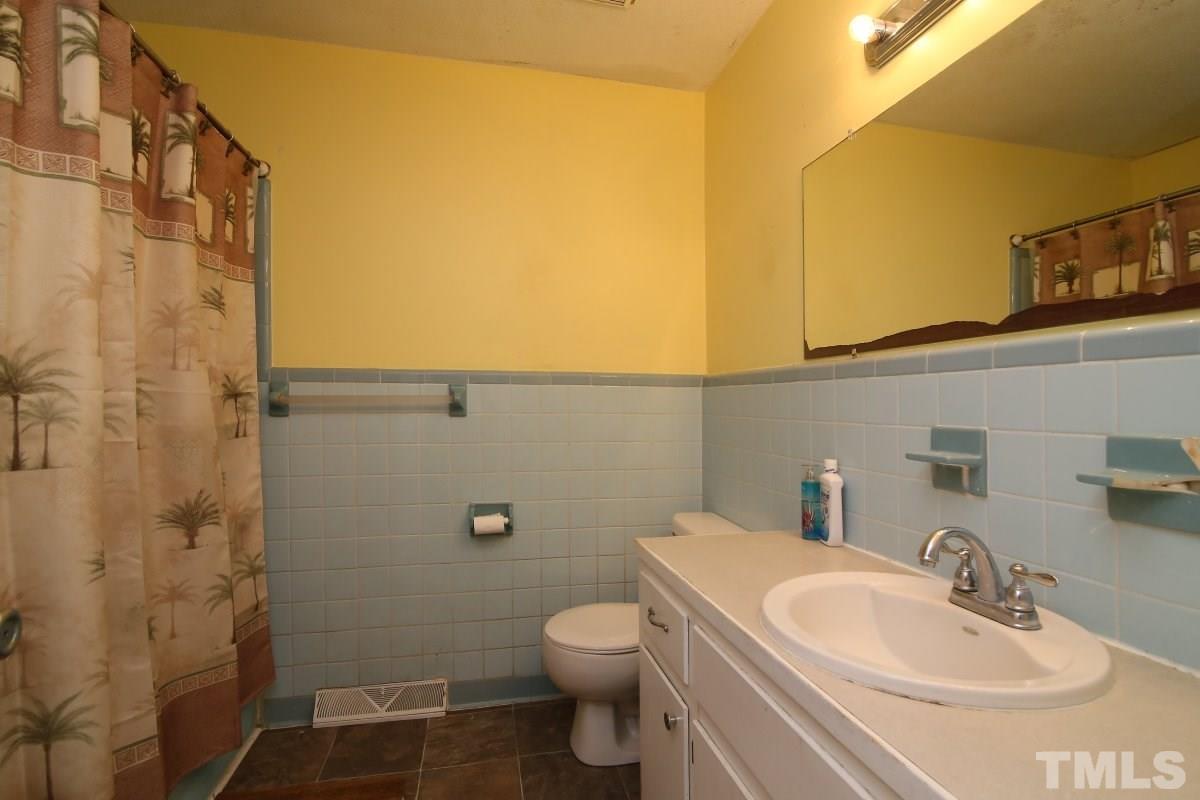 1629 Gate 2 Road Creedmoor, NC 27522 - Photo 8 of 22 a bathroom with a sink a toilet and shower