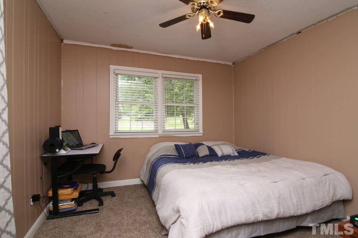 1629 Gate 2 Road Creedmoor, NC 27522 - Photo 9 of 22 a bedroom with a bed and a chandelier