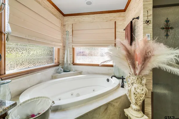 a bathroom with a bathtub and window