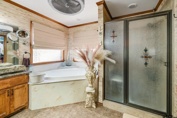 a bathroom with a sink a mirror and shower