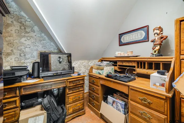 a view of a kitchen with stainless steel appliances granite countertop a stove and cabinets
