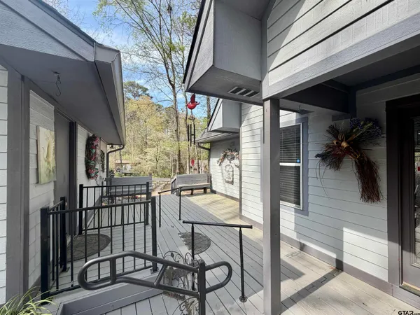 a view of a porch with furniture and a yard