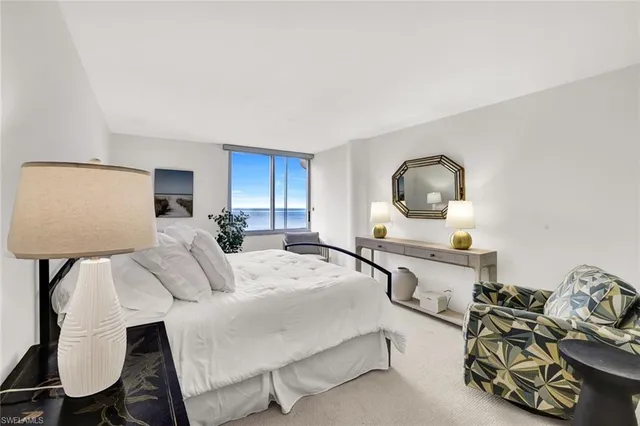 a bed room with furniture and a chair