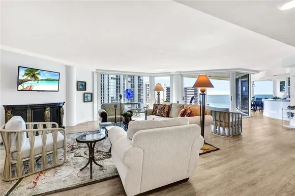 a living room with furniture and a wooden floor
