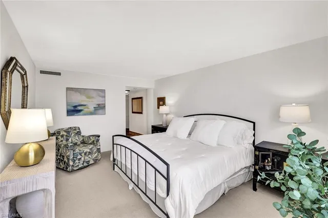 a bedroom with two beds and potted plant