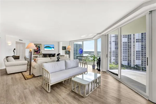 a living room with furniture and a large window