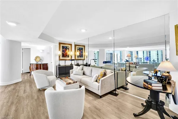 a living room with furniture and a wooden floor