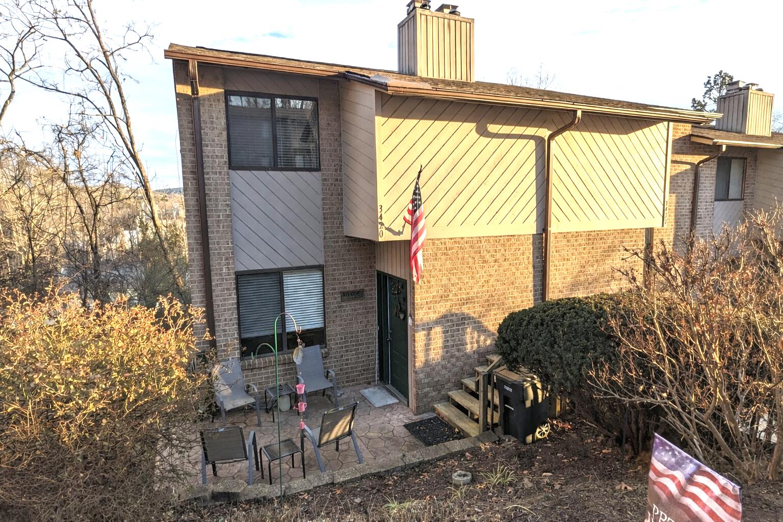 a backyard of a house with table and chairs