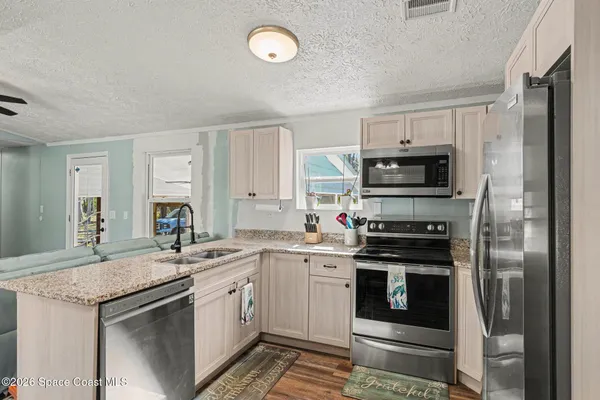 a kitchen with a sink stove and refrigerator