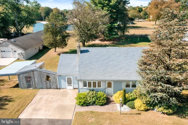 an aerial view of a house with a yard and lake view