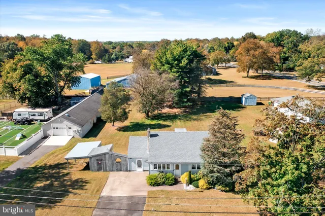 an aerial view of lake residential house with swimming pool and outdoor space