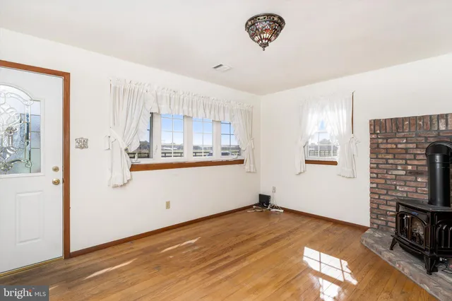 a view of a kitchen with wooden floor and a window