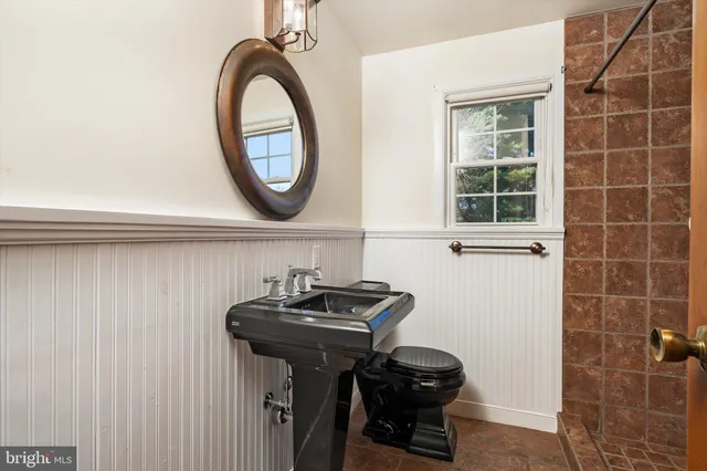 a bathroom with a sink a mirror and a window