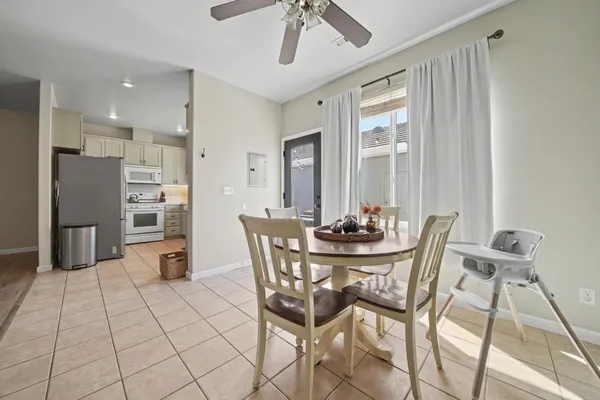 a view of a dining room with furniture and chandelier