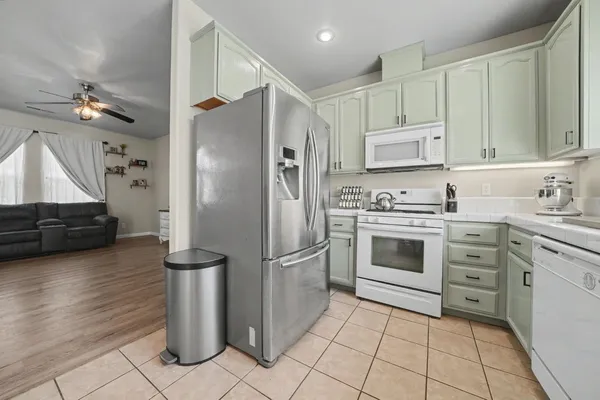 a kitchen with a refrigerator sink and cabinets