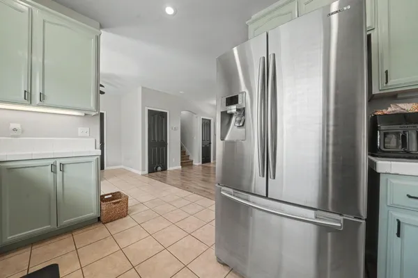 a kitchen with stainless steel appliances a refrigerator and a sink