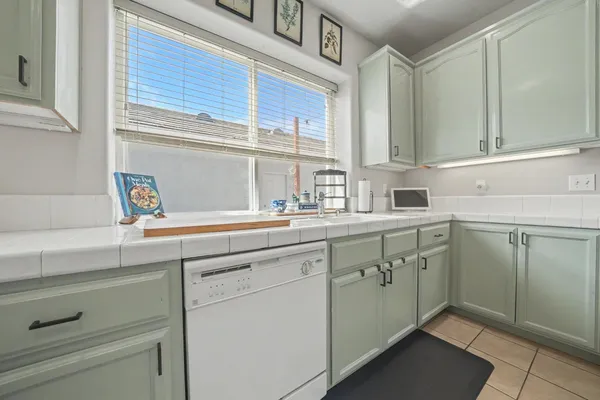 a kitchen with sink cabinets and a window
