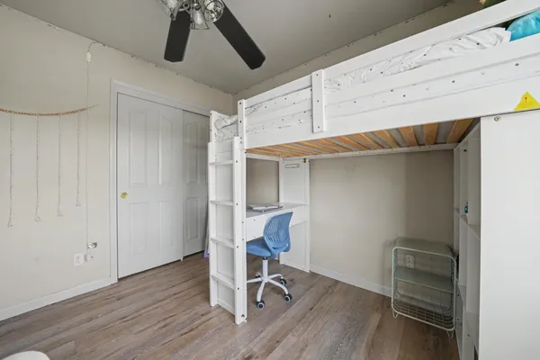 a view of room with wooden floor and white cabinet