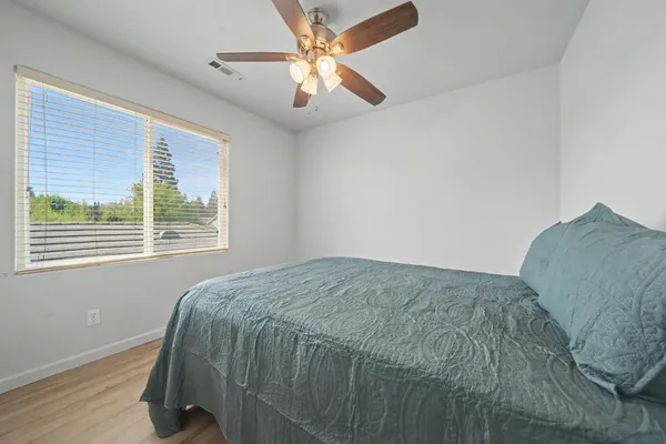 a bedroom with a bed and a large window