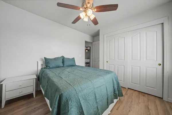a spacious bedroom with a bed and a chandelier