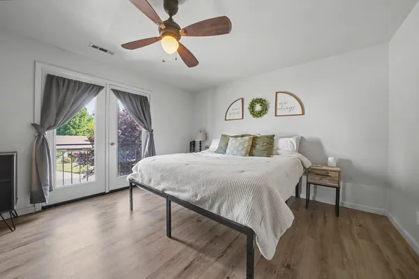 a bedroom with a bed and a large window