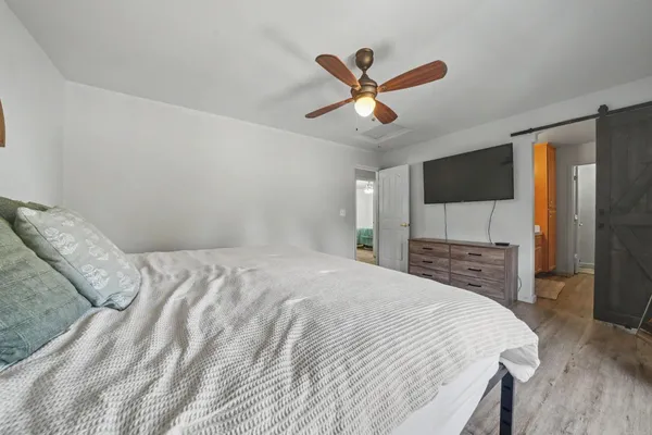 a bedroom with a bed and a flat screen tv