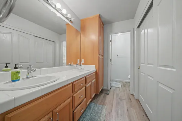 a bathroom with a double vanity sink and a mirror