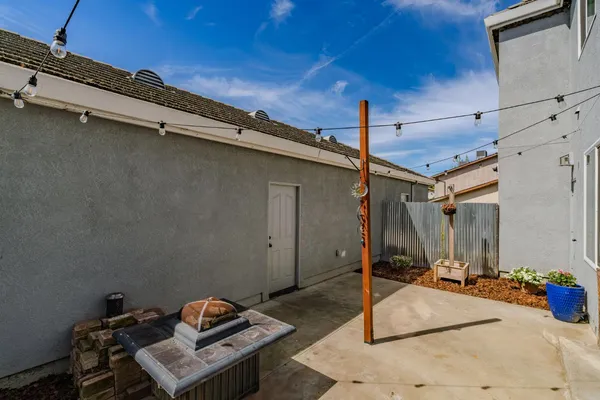 a view of a house with a backyard and wooden wall
