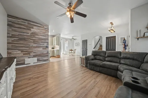 a living room with furniture and a wooden floor