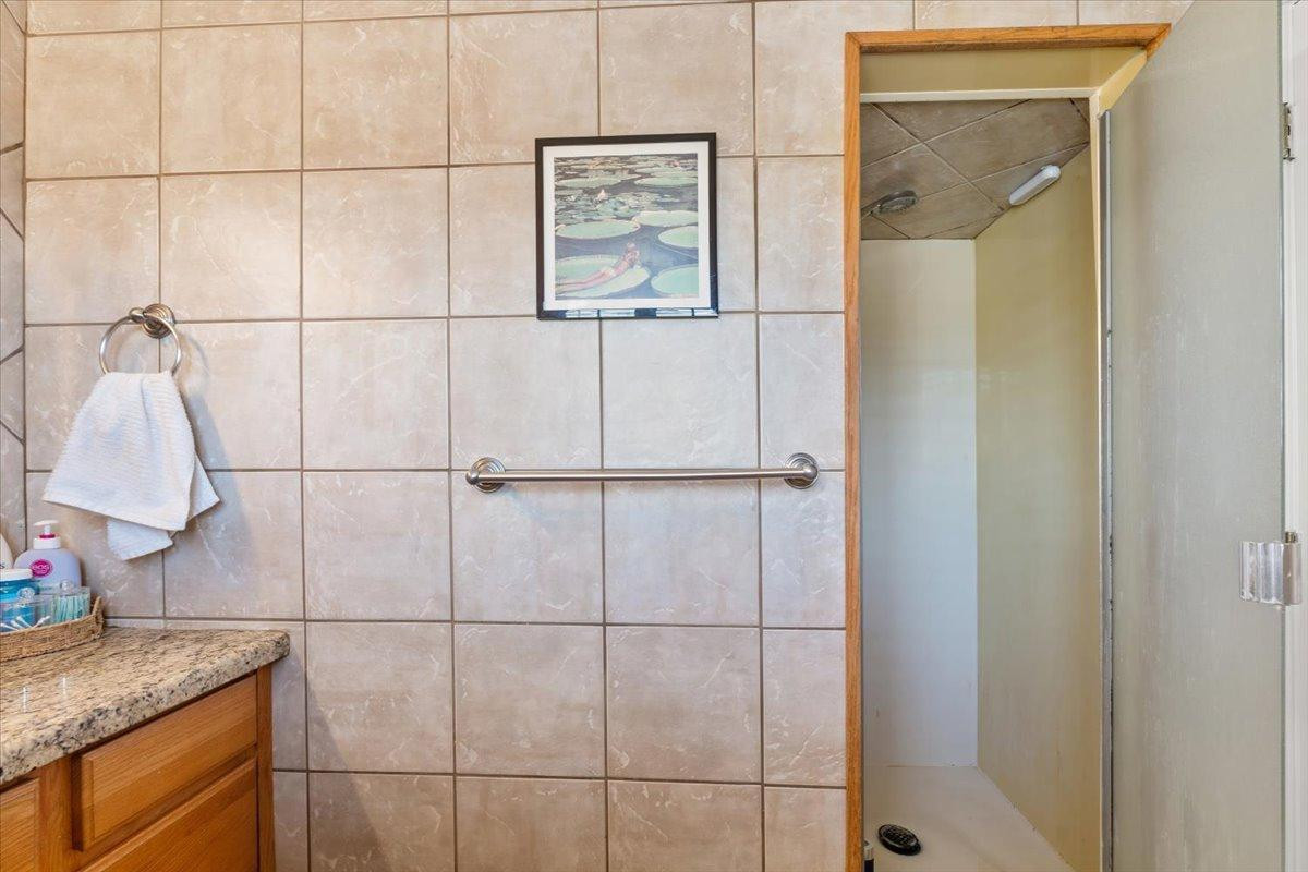 535 West 19th Street Tempe, AZ 85282 - Photo 13 of 20 a bathroom with a granite countertop shower and a sink