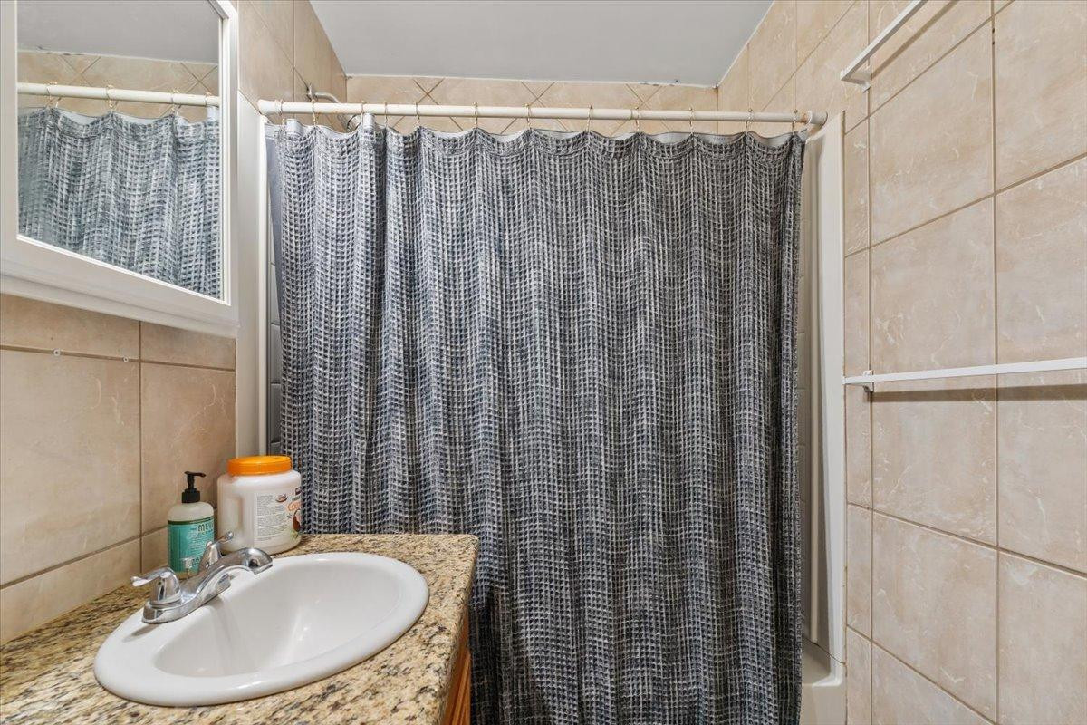 535 West 19th Street Tempe, AZ 85282 - Photo 15 of 20 a bathroom with a sink a toilet and shower curtain