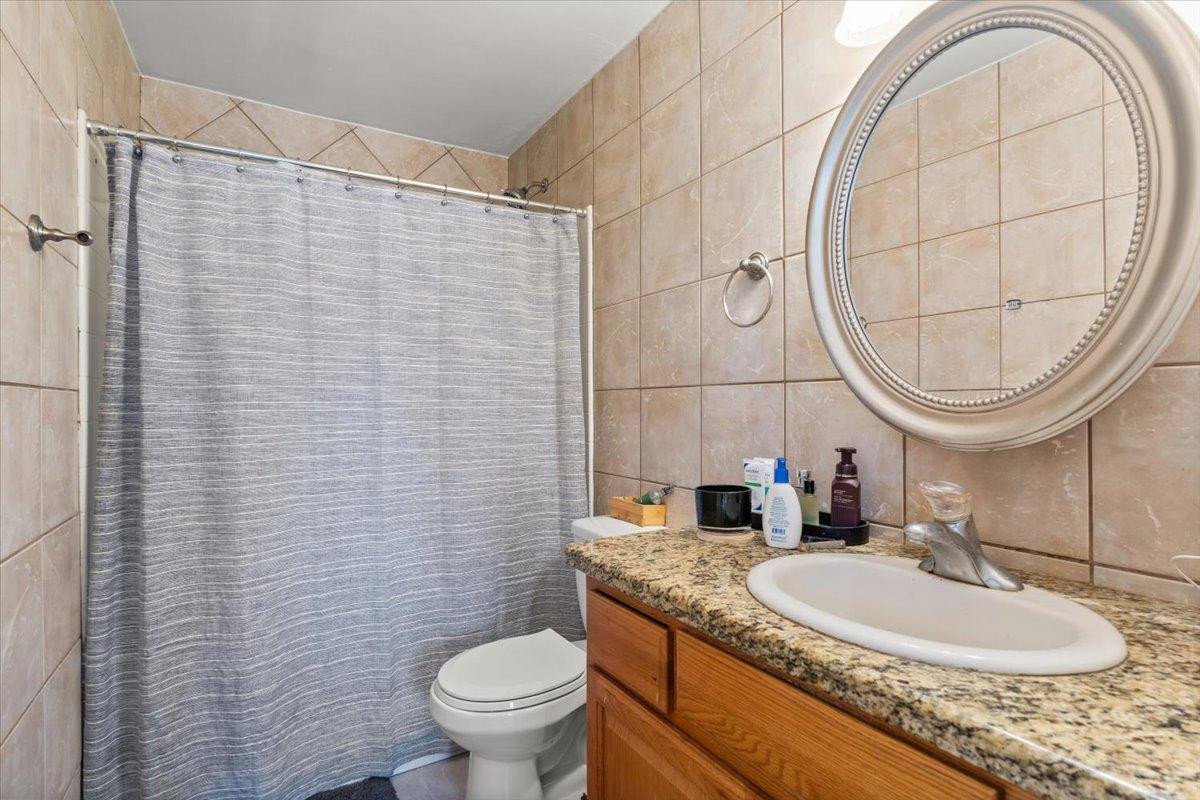 535 West 19th Street Tempe, AZ 85282 - Photo 17 of 20 a bathroom with a granite countertop sink a toilet and a mirror