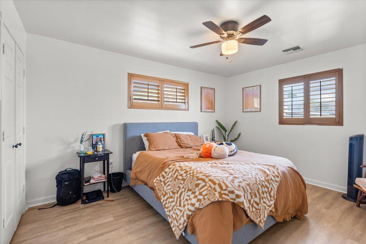 535 West 19th Street Tempe, AZ 85282 - Photo 10 of 20 a bedroom with a bed and wooden floor