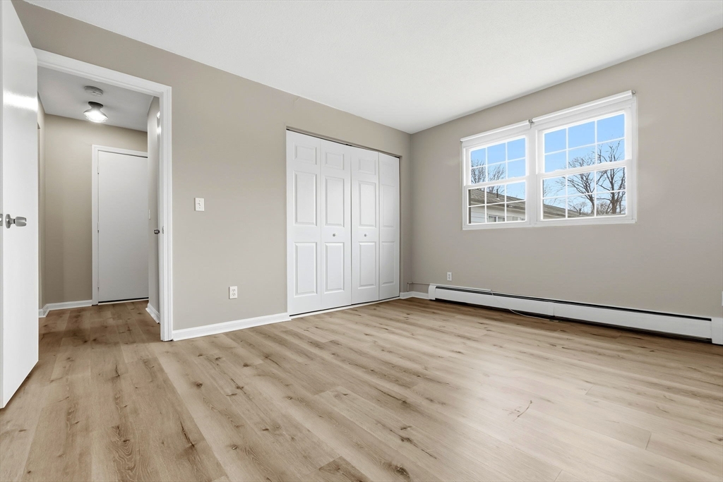 6 Venice Street, Unit B6 Danvers, MA 01923 - Photo 11 of 19 a view of an empty room with wooden floor and a window