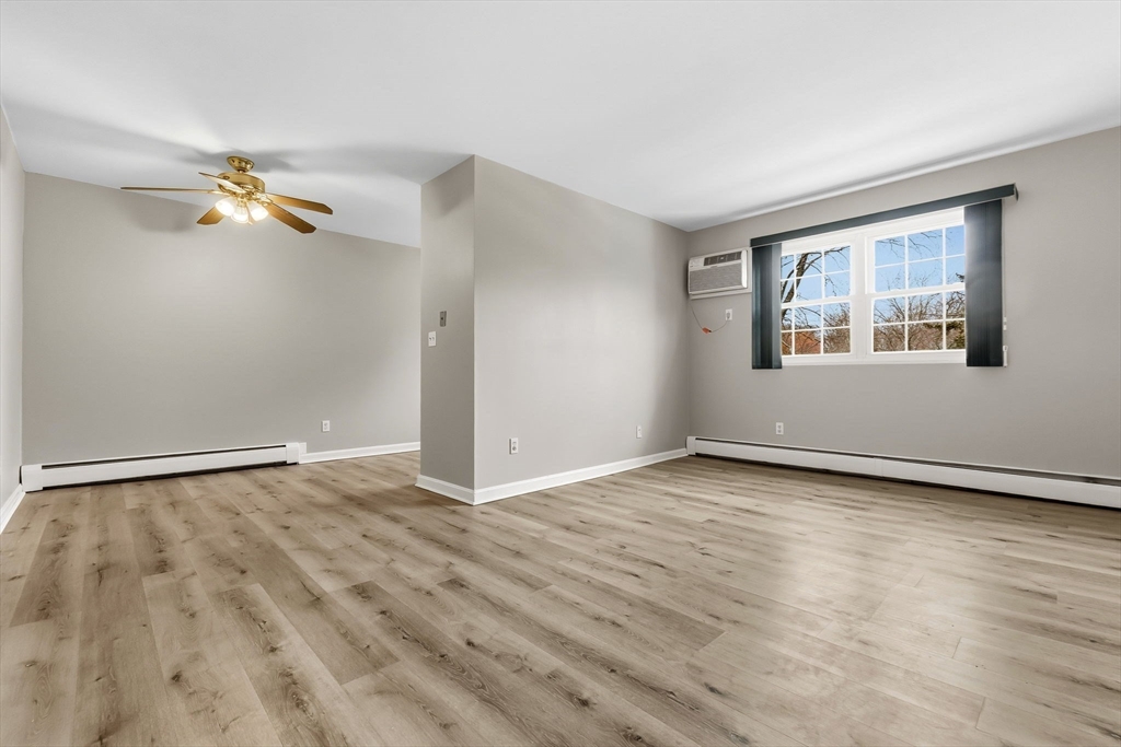6 Venice Street, Unit B6 Danvers, MA 01923 - Photo 2 of 19 an empty room with wooden floor fan and windows