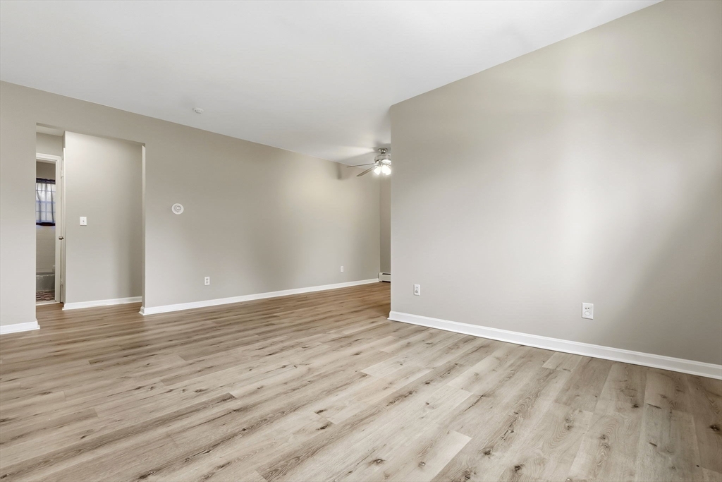 6 Venice Street, Unit B6 Danvers, MA 01923 - Photo 3 of 19 a view of an empty room with wooden floor