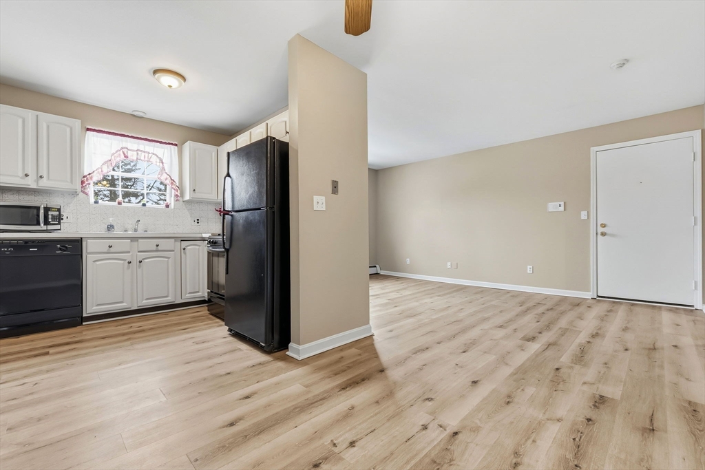 6 Venice Street, Unit B6 Danvers, MA 01923 - Photo 5 of 19 a kitchen with granite countertop a refrigerator and a sink