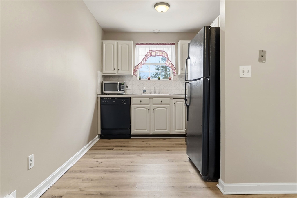 6 Venice Street, Unit B6 Danvers, MA 01923 - Photo 6 of 19 a kitchen with stainless steel appliances granite countertop a refrigerator and a sink