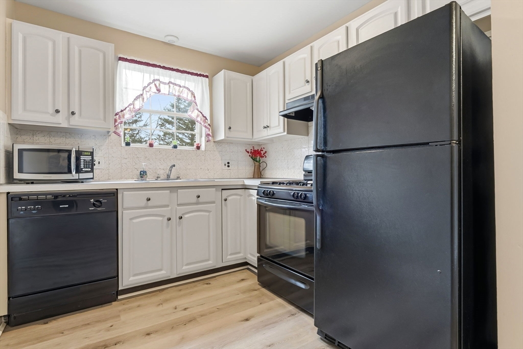 6 Venice Street, Unit B6 Danvers, MA 01923 - Photo 7 of 19 a kitchen with stainless steel appliances a refrigerator sink and stove