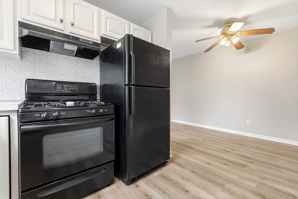 6 Venice Street, Unit B6 Danvers, MA 01923 - Photo 8 of 19 a kitchen with granite countertop cabinets and steel stainless steel appliances