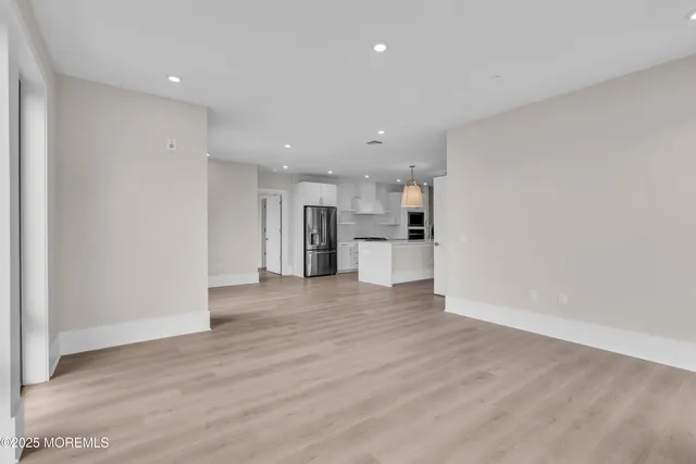 a view of kitchen with refrigerator stove microwave and cabinets