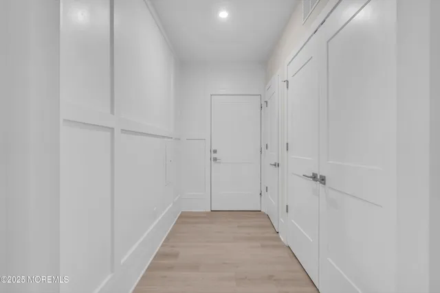 a view of a hallway with white walls