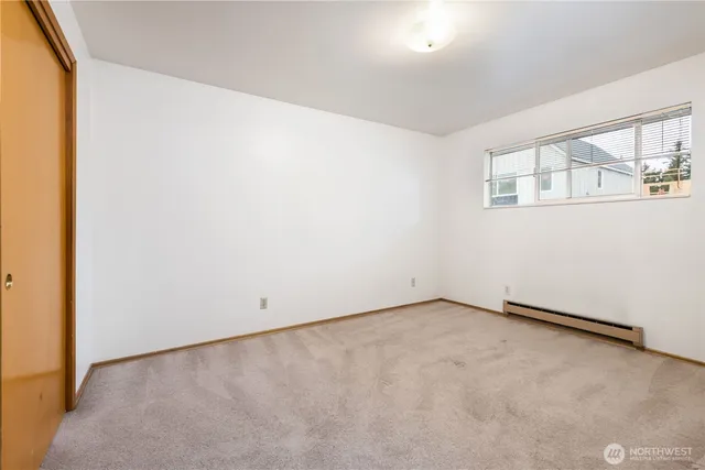 a kitchen with a stove a sink dishwasher and a refrigerator with wooden floor