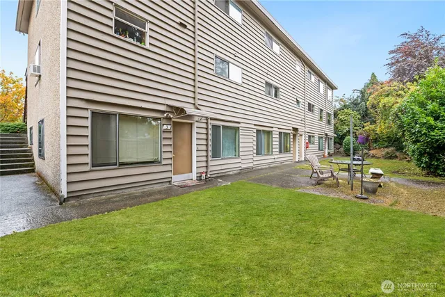 a view of a patio with table and chairs and potted plants