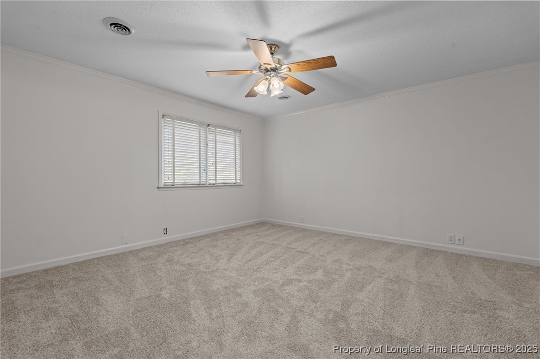2000 Airport Road Whispering Pines, NC 28327 - Photo 27 of 50 an empty room with a window and a fan