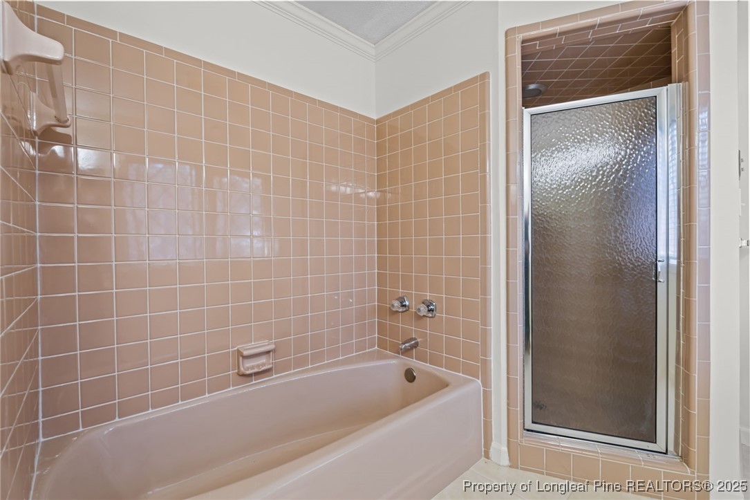 2000 Airport Road Whispering Pines, NC 28327 - Photo 29 of 50 a bathroom with a bathtub and a shower