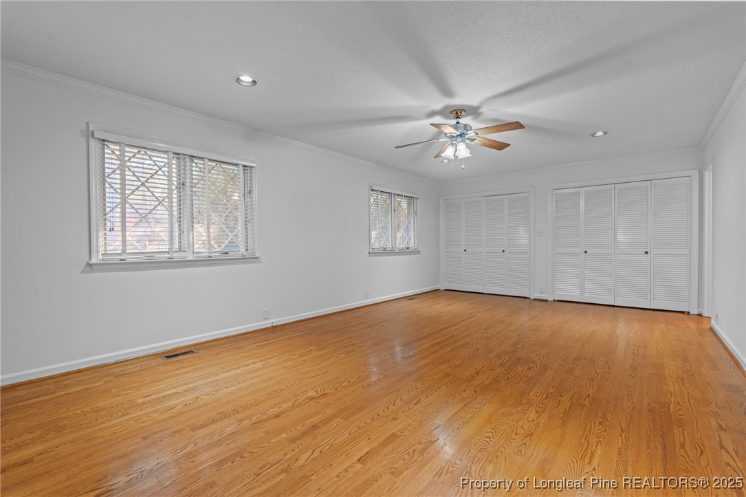 2000 Airport Road Whispering Pines, NC 28327 - Photo 31 of 50 a view of empty room with wooden floor and fan