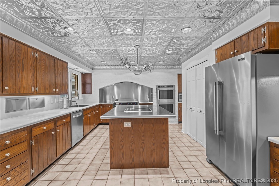 2000 Airport Road Whispering Pines, NC 28327 - Photo 43 of 50 a large kitchen with stainless steel appliances granite countertop a sink a counter space and cabinets