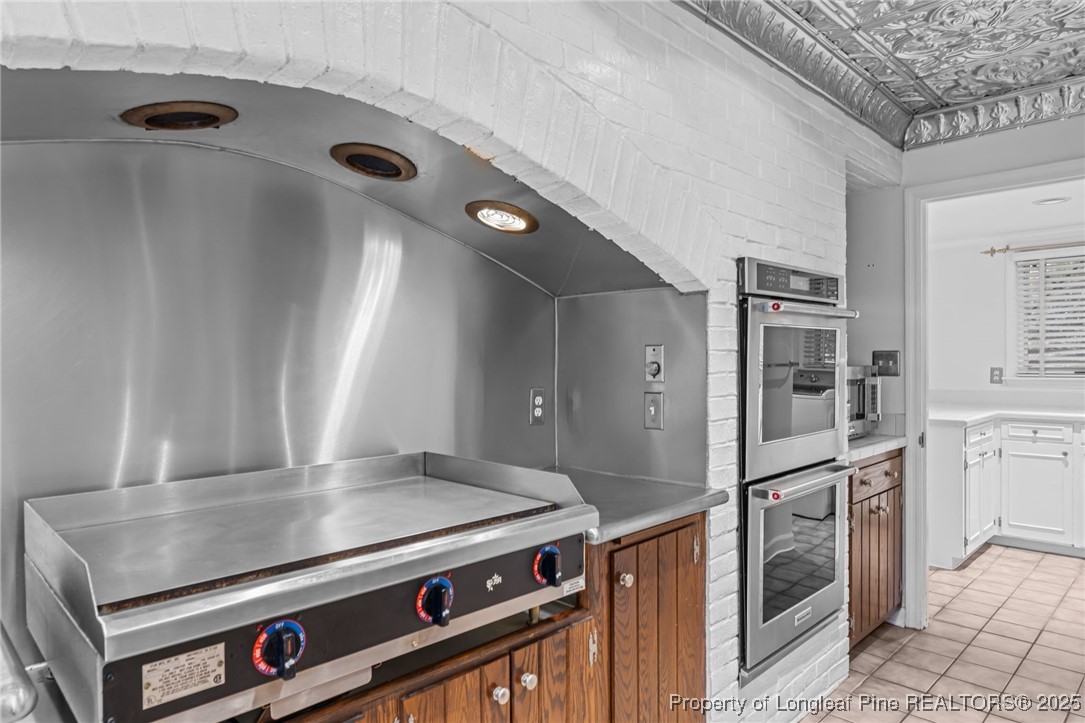 2000 Airport Road Whispering Pines, NC 28327 - Photo 48 of 50 a kitchen with stainless steel appliances granite countertop a refrigerator and a stove
