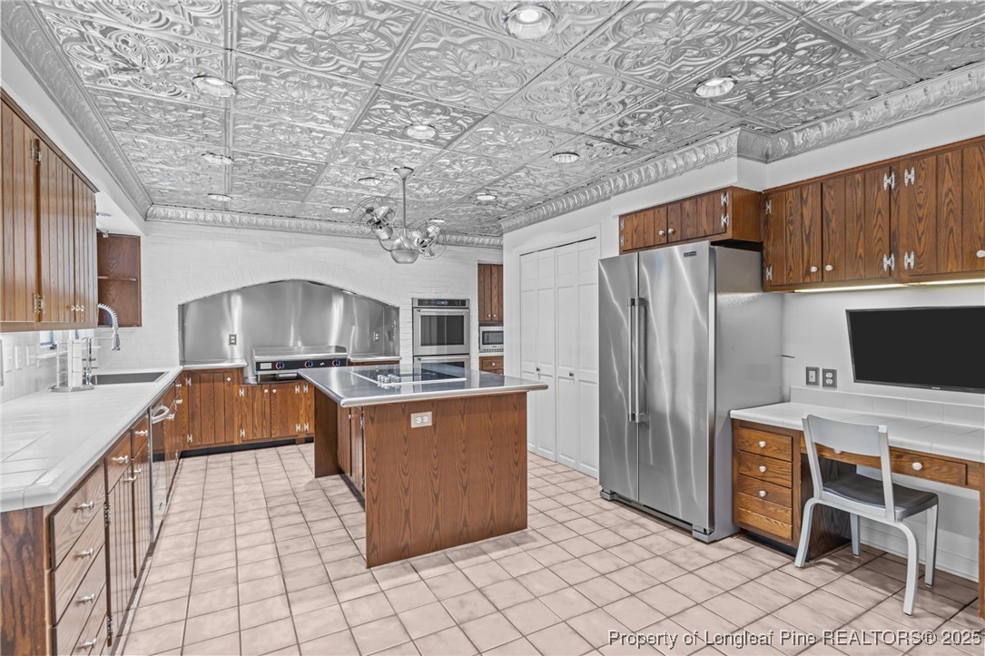 2000 Airport Road Whispering Pines, NC 28327 - Photo 50 of 50 a kitchen with stainless steel appliances granite countertop a stove a sink dishwasher and a refrigerator with cabinets